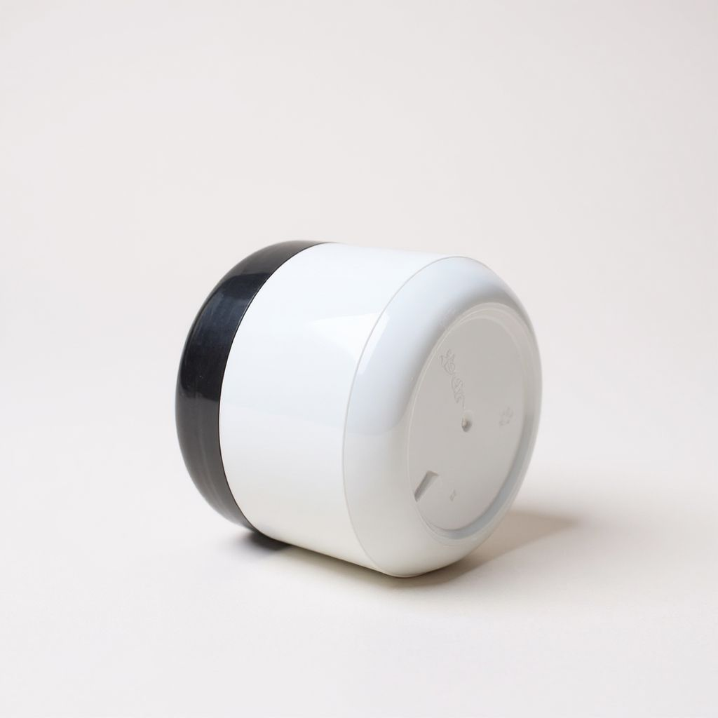 white cosmetic cream jar with black lid